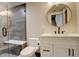 Modern bathroom with walk-in shower, circular mirror, and white vanity at 5334 Sedona Dr, Parker, CO 80134