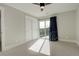 This is a light and airy bedroom with a ceiling fan and sliding glass doors to a balcony at 5334 Sedona Dr, Parker, CO 80134