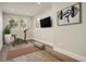 Bright exercise room with hardwood floors, mounted TV, and large windows at 5334 Sedona Dr, Parker, CO 80134