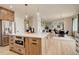 Open concept kitchen with stainless appliances, large island and seamless flow to living and dining areas at 5334 Sedona Dr, Parker, CO 80134