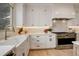 Bright kitchen with white cabinetry, stainless steel appliances, and a farmhouse sink at 5334 Sedona Dr, Parker, CO 80134