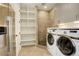 The laundry room has side-by-side washer and dryer, along with a tiled walk-in shower at 5334 Sedona Dr, Parker, CO 80134