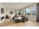 Bright living room features a large sectional sofa, modern fireplace, and large windows with scenic views at 5334 Sedona Dr, Parker, CO 80134