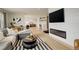 Open-concept living room with a modern fireplace and seamless flow into the kitchen and dining area at 5334 Sedona Dr, Parker, CO 80134