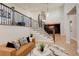 Elegant living room with hardwood floors, a modern railing, and staircase views of the dining room at 5334 Sedona Dr, Parker, CO 80134