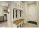 Mudroom boasts a wooden bench, coat hooks, and storage space with white trim at 5334 Sedona Dr, Parker, CO 80134