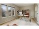 Bright home office with modern desk, shelving, and multiple windows at 5334 Sedona Dr, Parker, CO 80134