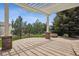 Back patio with outdoor fireplace and pergola at 5334 Sedona Dr, Parker, CO 80134