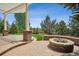 Back patio with an outdoor brick fireplace and a view of the yard at 5334 Sedona Dr, Parker, CO 80134