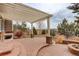 Outdoor patio features a pergola, brick columns, fire pit and beautiful landscaping for entertaining at 5334 Sedona Dr, Parker, CO 80134