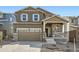 Beautiful two-story home featuring stone accents, a covered front porch, and a two-car garage at 28624 E 7Th Ave, Watkins, CO 80137