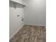 A clean and functional laundry room with tile floors and overhead shelf at 28624 E 7Th Ave, Watkins, CO 80137