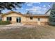 Back of home with sliding glass door, small patio and a combination of siding and brick at 12014 E Mexico Ave, Aurora, CO 80012