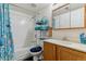 Bathroom with a bathtub, shower, large mirror and wooden vanity with drawers at 12014 E Mexico Ave, Aurora, CO 80012