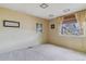 Bedroom with neutral carpet and wall color, window with blinds, and decorative wall art at 12014 E Mexico Ave, Aurora, CO 80012