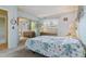 Comfortable bedroom with a large floral pattern bedspread and mirrored closet doors at 12014 E Mexico Ave, Aurora, CO 80012