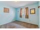 Cozy bedroom with soft carpeting, blue painted walls and a framed mirror at 12014 E Mexico Ave, Aurora, CO 80012