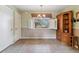 Cozy dining area with window shutters, tiled floor, and an open cabinet at 12014 E Mexico Ave, Aurora, CO 80012