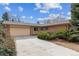 Well-kept single-story home features a large driveway, a two-car garage, and mature landscaping at 12014 E Mexico Ave, Aurora, CO 80012