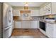 Bright kitchen with white cabinets, stainless steel appliances, and tiled floor at 12014 E Mexico Ave, Aurora, CO 80012