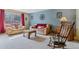 Comfortable living room with matching sofas, a patterned accent wall, and a rocking chair at 12014 E Mexico Ave, Aurora, CO 80012