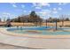Vibrant community playground with swings, slides, and a large splash pad area at 12014 E Mexico Ave, Aurora, CO 80012