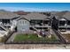 Aerial view of backyard featuring porch, stairs, fenced yard, and stone patio at 21916 E Swallow Pl, Aurora, CO 80016