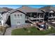 Back of house featuring porch, stairs, fenced yard, and a stone patio at 21916 E Swallow Pl, Aurora, CO 80016