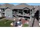 Back of house featuring porch, stairs, and patio seating at 21916 E Swallow Pl, Aurora, CO 80016