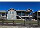 The back of the house features a porch, stairs, fenced backyard, and a stone patio at 21916 E Swallow Pl, Aurora, CO 80016