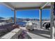 Spacious deck with covered patio, outdoor furniture, and snowy landscape views at 21916 E Swallow Pl, Aurora, CO 80016