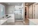 Modern bathroom features a glass enclosed shower, soaking tub, and stylish tile work at 21916 E Swallow Pl, Aurora, CO 80016