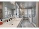 Bright bathroom featuring soaking tub, walk-in shower with glass door, and tiled floor at 21916 E Swallow Pl, Aurora, CO 80016