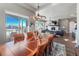 Inviting dining room with wood table, decorative lighting, and view of the snowy outdoors at 21916 E Swallow Pl, Aurora, CO 80016