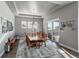 Bright dining room features a large table, chandelier, and access to a deck at 21916 E Swallow Pl, Aurora, CO 80016