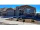 Lovely home showcasing a three-car garage, stone accents, and neat landscaping at 21916 E Swallow Pl, Aurora, CO 80016