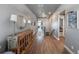 Hallway view of a home featuring hardwood floors and a decorative console table at 21916 E Swallow Pl, Aurora, CO 80016
