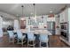 Gourmet kitchen with center island with bar stool seating, stainless steel appliances, and plenty of cabinet space at 21916 E Swallow Pl, Aurora, CO 80016