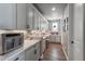 Bright butler's pantry featuring extensive cabinets, ample counter space, and stylish tile backsplash at 21916 E Swallow Pl, Aurora, CO 80016