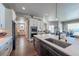 Modern kitchen with a large center island, stainless steel appliances, and seamless flow to the living areas at 21916 E Swallow Pl, Aurora, CO 80016
