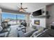 Bright living room featuring a cozy fireplace, ceiling fan and sliding glass doors that bring in an abundance of light at 21916 E Swallow Pl, Aurora, CO 80016