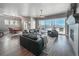 Open-concept living room featuring large windows, hardwood floors, and a fireplace at 21916 E Swallow Pl, Aurora, CO 80016