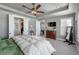 Spacious main bedroom featuring tray ceilings, a ceiling fan and ensuite bathroom and closet at 21916 E Swallow Pl, Aurora, CO 80016