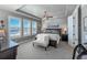 Bright main bedroom features large windows with plantation shutters and tray ceiling with ceiling fan at 21916 E Swallow Pl, Aurora, CO 80016