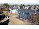Aerial view of backyard with covered patio, playset, mature trees, and grassy lawn at 7404 La Quinta Ln, Lone Tree, CO 80124