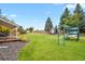 Spacious backyard with lush lawn, wooden fence, and a covered patio area at 7404 La Quinta Ln, Lone Tree, CO 80124
