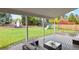 Covered deck overlooks a large yard featuring a playhouse and playground equipment at 7404 La Quinta Ln, Lone Tree, CO 80124