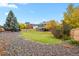 Spacious backyard includes a lush lawn, mature trees, and a rock garden area at 7404 La Quinta Ln, Lone Tree, CO 80124
