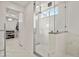 Elegant glass shower featuring marble tile, and a view into a walk-in closet at 7404 La Quinta Ln, Lone Tree, CO 80124