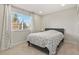 Cozy bedroom with neutral tones, large window, and natural light at 7404 La Quinta Ln, Lone Tree, CO 80124